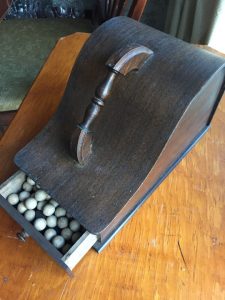Image: Wooden throw thingy with balls and squares - Kelly McCarthy